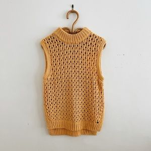 Foxy gold sweater vest with slits on the side.